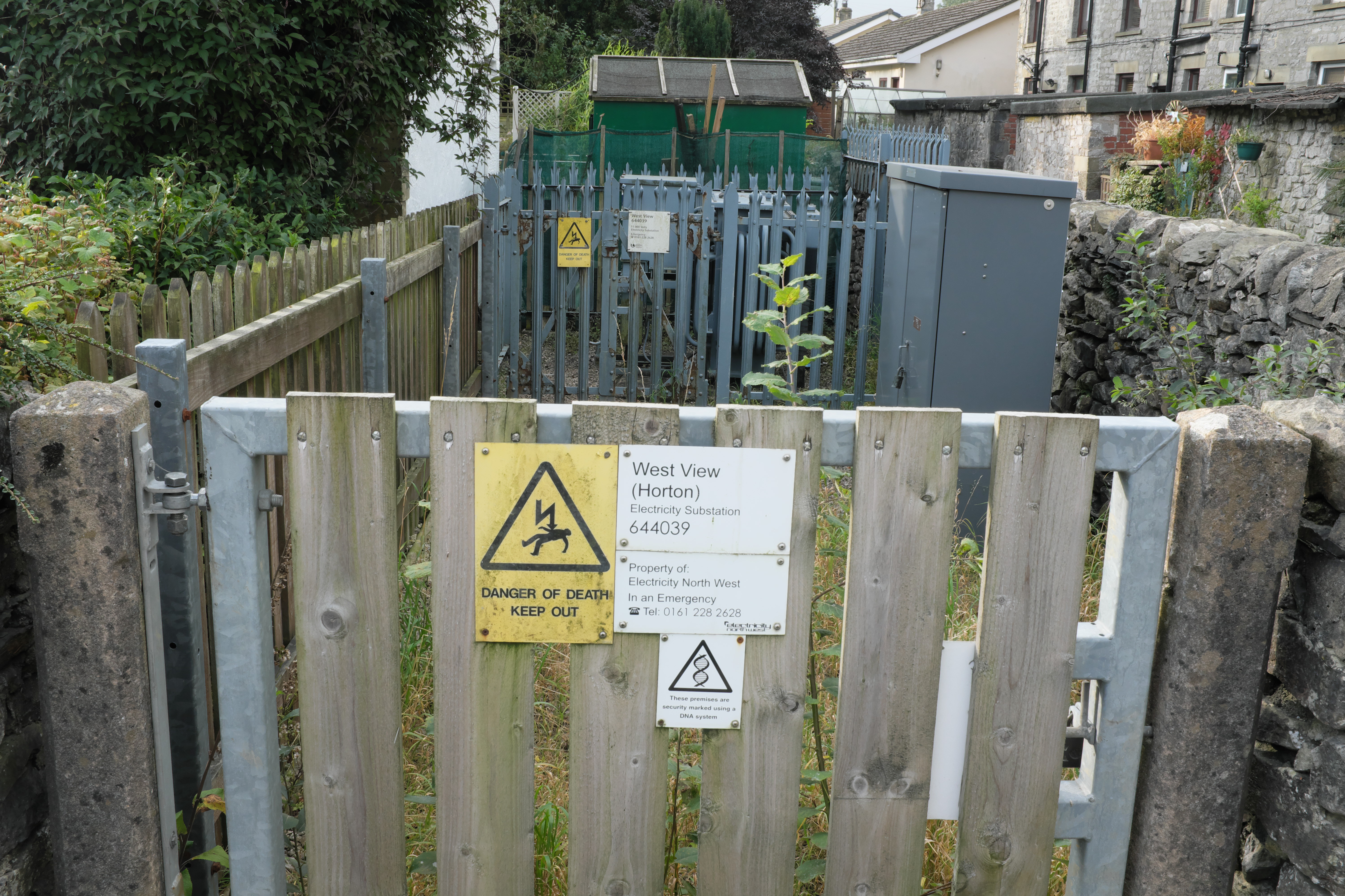 Electrical substation equipment beneath power lines in rural England